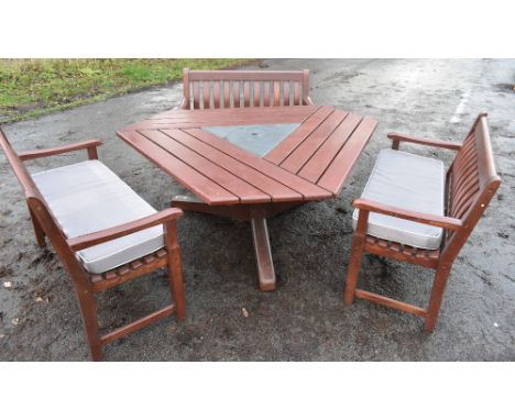 ALEXANDER ROSE; a stylish garden suite comprising triangular shaped table and set of three benches, each bench 123cm, table a