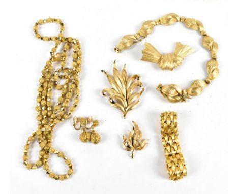 CROWN TRIFARI; a vintage 1960s gold tone three strand bead set with matching clip-on drop earrings, a textured twisted gold t