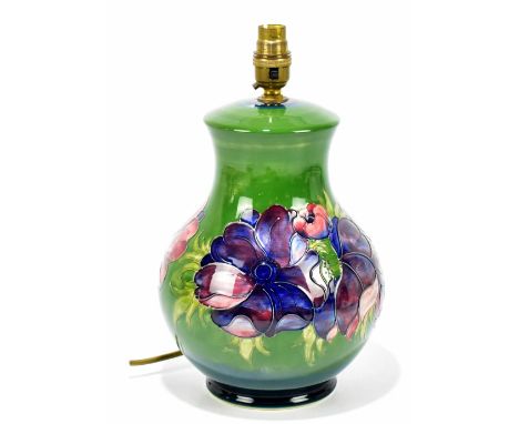 MOORCROFT; a baluster table lamp decorated in the 'Anemone' pattern on a green ground, height excluding fitting 26cm.&nbsp;Ad