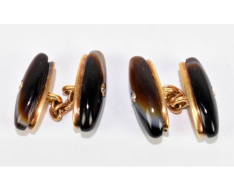 A pair of yellow metal agate and diamond cufflinks, each with twin torpedo ends centred with a tiny diamond and with chain li