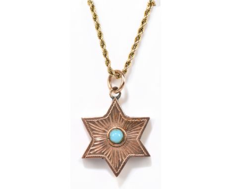 A yellow metal star shaped pendant centred with a cabochon turquoise suspended on fancy 9ct yellow gold chain,&nbsp;approxima