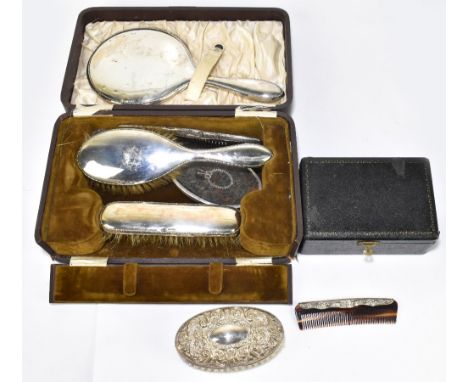 A George V hallmarked silver three piece dressing table set, Chester 1915, in box, with a silver and tortoiseshell hand mirro