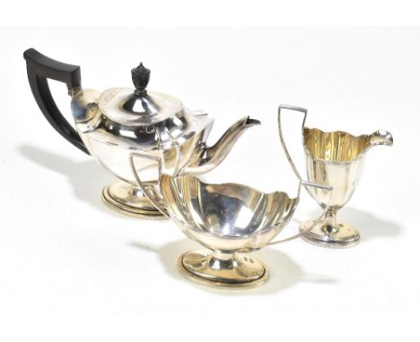 THOMAS BRADBURY &amp; SONS; a Victorian hallmarked silver three piece tea service of oval form with panelled bodies, London 1