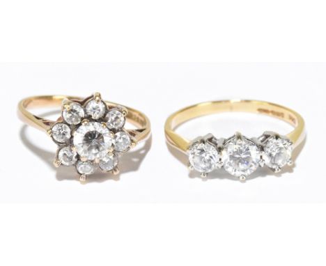 Two 9ct yellow gold dress rings formed as a flower head ring and a three stone ring, size M and K 1/2, combined approx.&nbsp;