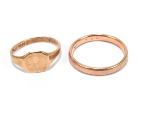 A 9ct gold wedding band,&nbsp;approximate size R, with a 9ct yellow gold signet ring with embossed decoration, combined weigh