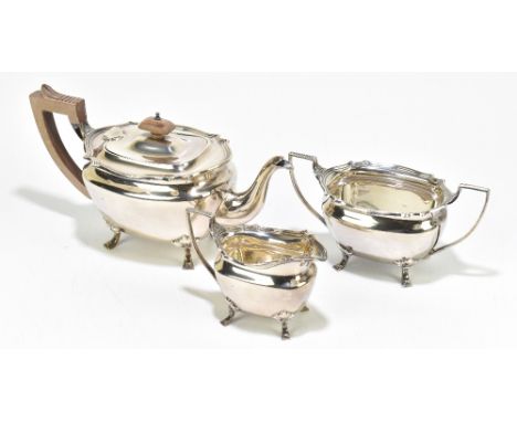 ADIE BROS; a George VI hallmarked silver three piece tea service of shaped oval form, on four scrolling feet, Birmingham 1947