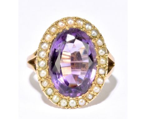 A 9ct yellow gold amethyst and seed pearl cluster ring, with pierced shoulders, size L, approx. 6.09g, the amethyst approx. 1