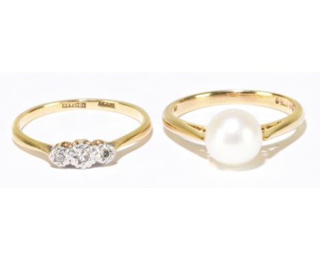 An 18ct yellow gold illusion set three stone diamond ring, size O, approx. 2g, and a 9ct yellow gold cultured pearl ring, siz
