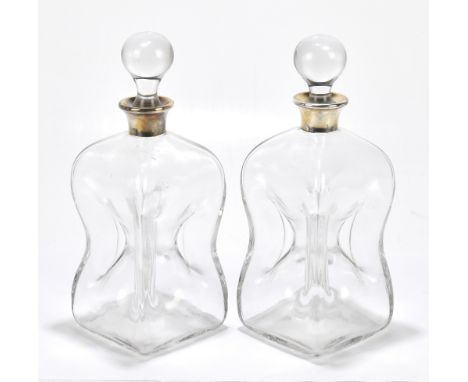 ASPREY &amp; CO; a pair of Elizabeth II hallmarked silver mounted decanters with pinched bodies, silver marks for London 1968