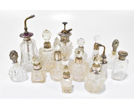 A collection of cut glass dressing table and perfume bottles with hallmarked silver collars/stoppers, one example with engrav