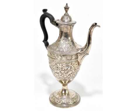 A George IV hallmarked silver coffee pot with urn finial and cast beaded rims, repoussé decorated with floral sprays and scro