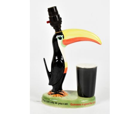 A Guinness toucan lamp, modelled beside a foaming pint of Guinness, printed marks to base, height including fitment 29cm.&nbs