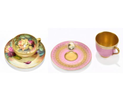 ROYAL WORCESTER; a hand painted cabinet cup and saucer decorated with roses by Twin, with a pink ground cabinet cup and sauce