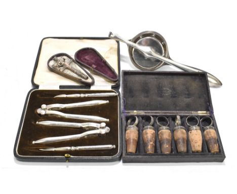 A cased set of six Continental white metal mounted bottle stoppers, indistinctly stamped, together with a cased set of Mappin