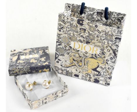 CHRISTIAN DIOR; a pair of faux pearl Tribales pierced earrings with large faux pearls adorned with maker's logo and star moti