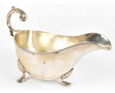 MAPPIN &amp; WEBB; a late Victorian hallmarked silver sauce boat with flying scroll handle, Sheffield 1897, 9.5ozt/296g, widt