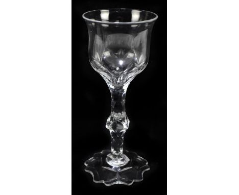 A 19th century Irish wine glass, with ogee shaped bowl and faceted stem with shaped base, and shaped foot, height 19.5cm.&nbs