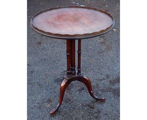 A George III style circular tripod table, with raised edge, height 70cm