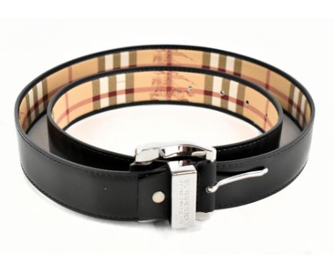 BURBERRY; an unused black calfskin leather gentleman's belt with silver tone buckle and maker's name and logo to front plaque