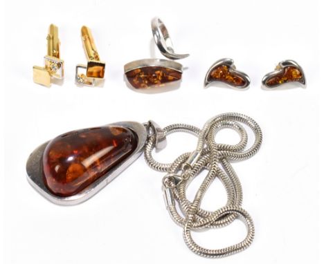 A white metal and Baltic amber pendant on chain, a matching ring and also ear studs, and a pair of gold plated cufflinks.