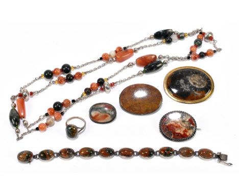 Four hardstone brooches including a 9ct yellow gold example, three white banded examples including moss agate, also a silver 