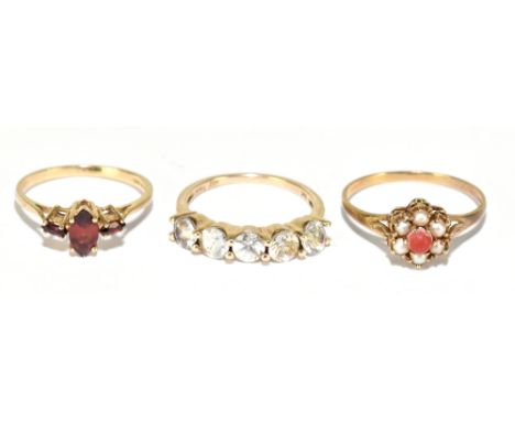 Three 9ct yellow gold dress rings including a claw set garnet, coral and pearl and a five stone half hoop, sizes M, R and N, 