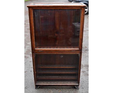 A unusual Victorian walking stick shop display cabinet with a single pull down front enclosing two shelves of recesses to hol