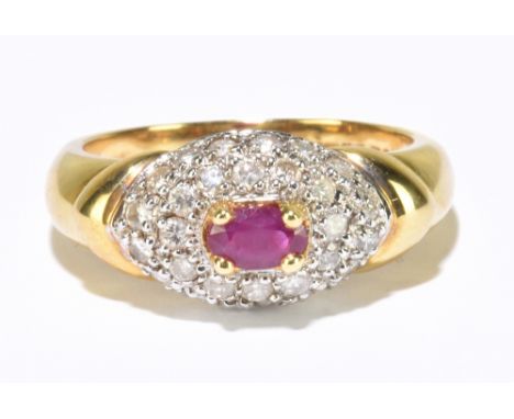 An 18ct yellow gold ruby and pave diamond set dress ring, size L 1/2, approx. 5.3g.&nbsp;Additional InformationSurface abrasi