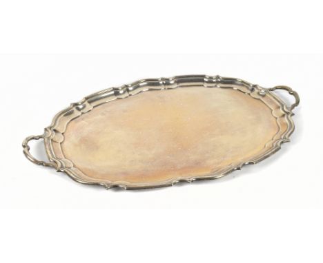 COOPER BROS; a George V hallmarked silver twin handled oval tray, with shaped rim, Sheffield 1936, 64ozt/2000g, width includi