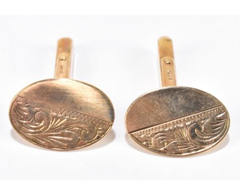 A pair of 9ct yellow gold cufflinks with part engraved scroll detail to the oval platforms,&nbsp;approximately 5.7g.&nbsp;Add