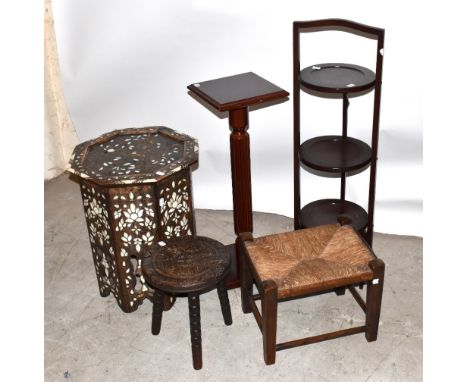 A small carved oak stool, diameter 30cm, with a circular occasional table, a cake stand, bone inlaid table and a lamp stand (