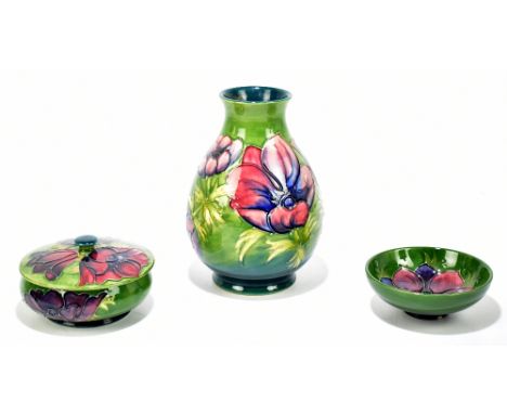 MOORCROFT; three pieces including a baluster vase decorated in the 'Anemone' pattern, height 20cm, powder bowl and cover in t