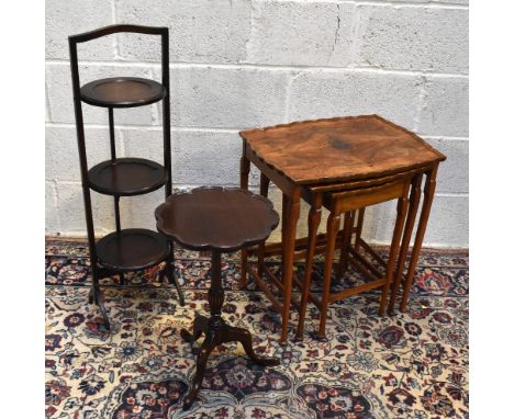 A 1930s walnut nest of three graduated coffee tables, together with a mahogany three tier folding cake stand and a mahogany t