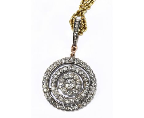 An Edwardian yellow metal diamond circular pendant formed of two outer rows and an inner row centred with a old cut diamond w