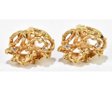 A pair of yellow metal cufflinks, each pierced naturalistic formed platform set with two tiny diamonds and stamped DB 14KT, t