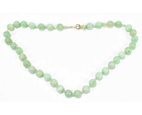 A 1920s/30s jade bead necklace, re-strung and with modern ring loop fastener, length 46cm, each bead approx. 10mm.