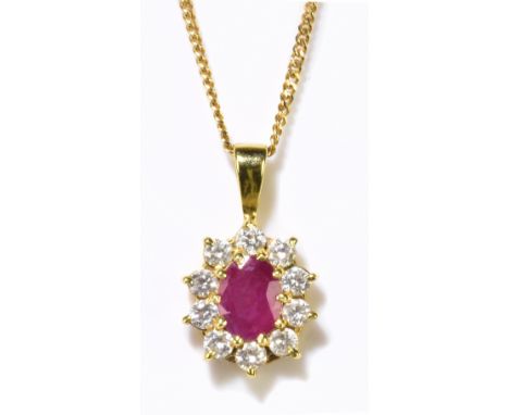 An 18ct yellow gold fine link chain, length 44cm, suspending a diamond and ruby oval pendant. length including bail 20mm, com