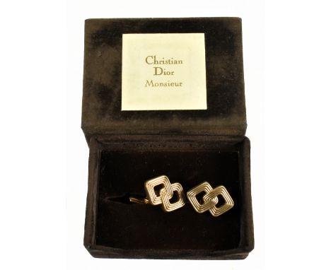 CHRISTIAN DIOR; a pair of 1980s gold tone interlocking geometric design cufflinks, in authentic Christian Dior brown velvet b