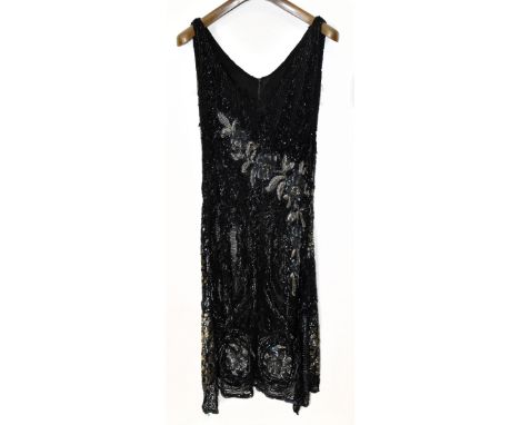 A 1920s black sleeveless V-neck beaded dress of lace and silk, decorated with black bugle beads, black and silver sequins and