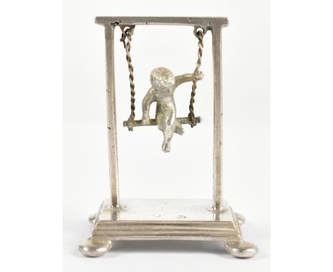 An early 20th century Dutch novelty silver model of a boy in a swing, weight 0.8ozt/25g, height 5.25cm.&nbsp;Additional Infor