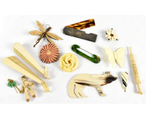 A collection of vintage 1930s bakelite and similar style brooches with a white metal back comb and two Oriental style fans.