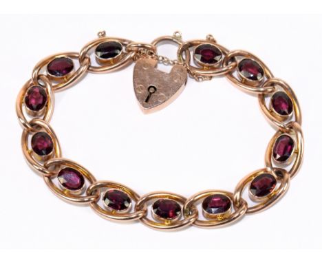 An early 20th century 9ct rose gold and garnet set open work bracelet with padlock clasp, length approx. 18cm, approx. 19.5g.