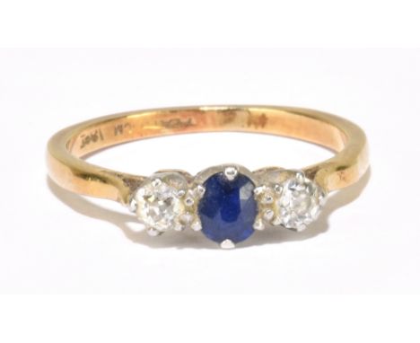 An 18ct yellow gold sapphire and diamond three stone ring with claws set in platinum, size K, approx. 2.37g.&nbsp;