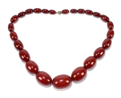 A vintage cherry amber graduated bead necklace, the largest bead 32 x 25mm, smallest 12 x 10mm, approx. 84.2g.Additional Info