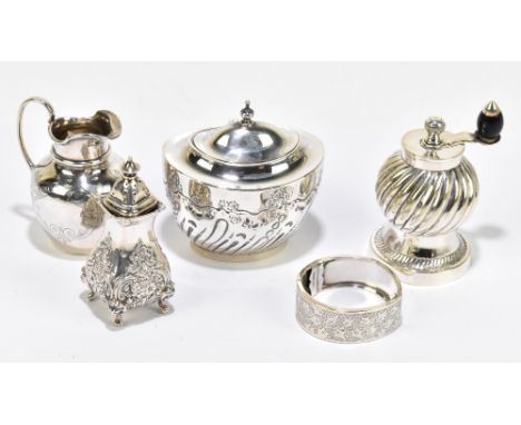 A Victorian hallmarked silver jug, with engraved detailing, London 1865, height 7.5cm, with a silver tea caddy, a silver pepp
