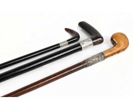 Two 19th century walking sticks, one example with inlaid decoration to the turned handle and with white metal cap embossed wi