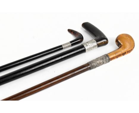 Two 19th century walking sticks, one example with inlaid decoration to the turned handle and with white metal cap embossed wi