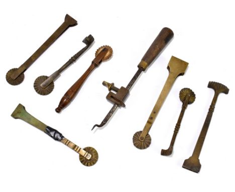 A group of seven 19th century pie edging tools, together with a 19th century tin opener.