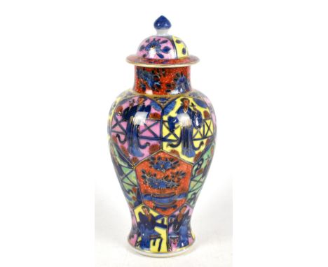 A 19th century Chinese porcelain clobbered jar and cover, decorated in panels with figures and floral detail, bears Kangxi do