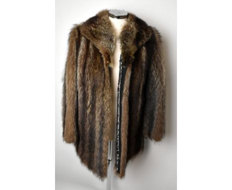A short light brown and cream fox fur fitted jacket with large collar, cuffed sleeves, front slit pockets and lined in a geom